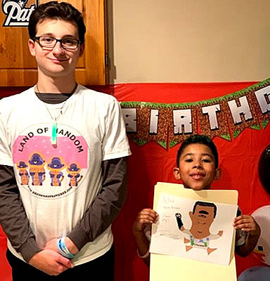 2020-PRESENT JOHN’S FIRST BIRTHDAY PARTY PRESENTATION, FEATURED WITH DAVID E, BIRTHDAY BOY PROUDLY HOLDING HIS SELF PORTRAIT AS A HANDOM CHARACTER.